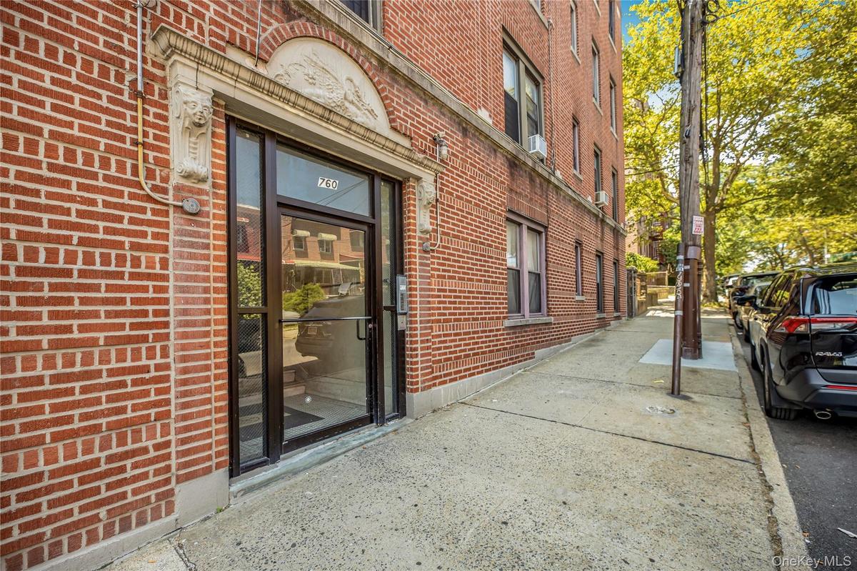 Property entrance featuring brick siding