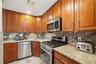 Unit 2 - Kitchen with stainless steel appliances. Digitally decluttered.