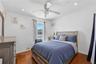 Unit 2 - Bedroom 2. Digitally decluttered; bedding and decor restyled.