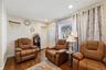 Unit 1 - Living room seating and front window. Digitally decluttered; some decor restyled.