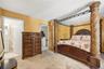 Unit 2 - Primary bedroom, reverse view. Digitally decluttered; bedding and decor restyled.