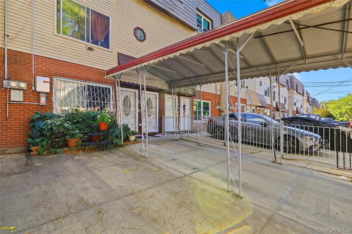 Covered front courtyard and entry area. Digitally decluttered.