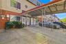 Covered front courtyard and entry area. Digitally decluttered.