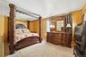 Unit 2 - Primary bedroom. Digitally decluttered; bedding and decor restyled.
