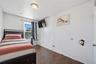 Unit 2 - Bedroom 3, reverse view. Digitally decluttered; bedding and decor restyled.