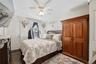 Unit 1 - Primary bedroom. Digitally decluttered; bedding and decor restyled.