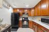 Unit 1 - Eat-in kitchen. Digitally decluttered; some decor restyled.