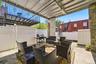 Covered rear porch and patio looking toward the backyard. Digitally decluttered.