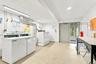 Supplemental bright and clean laundry facility is conveniently located one level down for co-op owners.