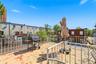 Rear balcony with the spiral staircase to the backyard. Digitally decluttered.