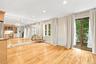 The mirrored wall makes the living space feel even larger than it is and the glass doors bring the outdoors in.