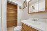 Unit 2 - Bathroom vanity and storage closet. Digitally decluttered.