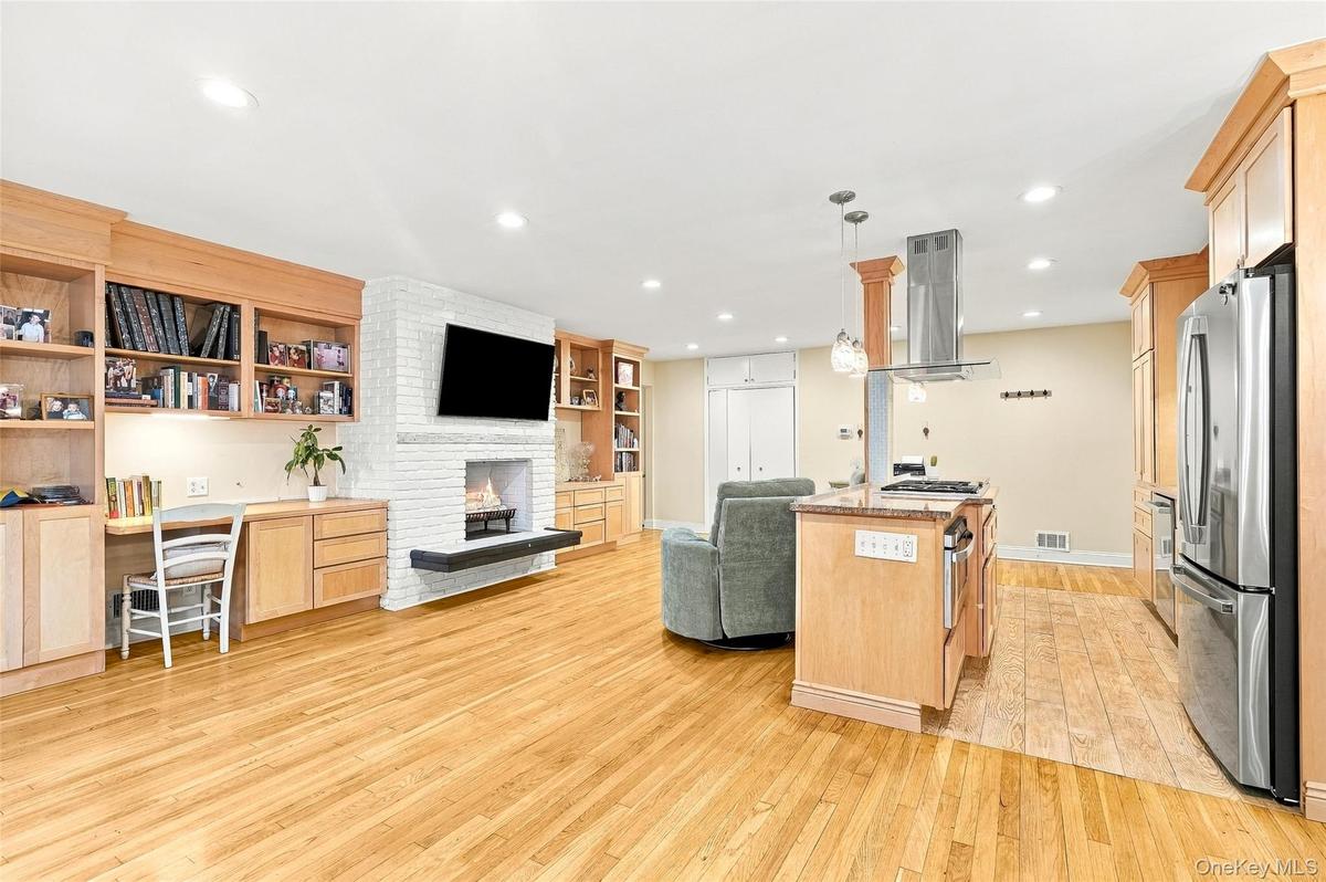 The open kitchen blends seamlessly into the living space including a cozy wood burning fireplace.
