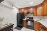Unit 1 - Kitchen range and dining nook. Digitally decluttered; some decor restyled.