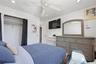 Unit 2 - Bedroom 2, closet view. Digitally decluttered; bedding and decor restyled.