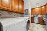 Unit 2 - Kitchen and in-unit laundry. Digitally decluttered.