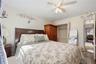 Unit 1 - Primary bedroom, reverse view. Digitally decluttered; bedding and decor restyled.