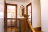 Wood-finish flooring, wood staircase with balusters, and wood door frames