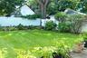 Expansive lawn with perimeter landscaping and mature trees , front and back sprinkler system