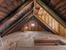 Full walk-up attic with plywood flooring throughout.