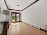 Spacious living room opens to dining room. with glass doors to rear deck