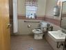 Bathroom featuring tile patterned flooring, a wainscoted wall, and tile walls