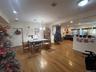 Dining room with dark wood-style floors and recessed lighting