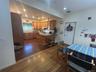 Kitchen with a peninsula, dark wood-style flooring, brown cabinets, recessed lighting, and a breakfast bar