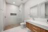 Beautifully designed guest bath featuring custom tile work and sophisticated finishes.