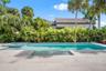 Heated saltwater pool has spa as well with plenty of sunlight and privacy.