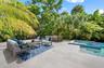 Virtually staged additional gathering space on pool deck in fenced and private back yard.
