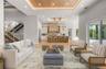 Virtually staged family room featuring a custom inlaid wood ceiling, flowing seamlessly into the kitchen and dining area.
