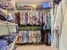 Walk in closet in primary bedroom.
