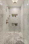An oversized marble shower designed with a true resort-level feel.