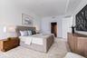 The primary suite balances quiet luxury with effortless connection to the view.