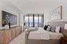 Wake above the water, where floor-to-ceiling glass frames the morning light.