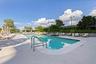 A resort-style pool deck tucked into lush, manicured surroundings.