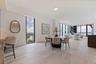 Open-concept living framed by floor-to-ceiling glass and elevated views.