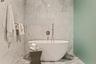 A sculptural soaking tub makes the primary bath feel distinctly spa-like.