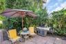 Additional patio space off the pool enclosure for furniture & grilling space~