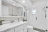 New vanity with stone top, fixtures, mirror, and recessed lighting~