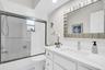 Beautifully updated hall bath with a new stone top vanity, fixtures, mirror, recessed lighting, and tub/shower combo~