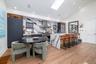 Large kitchen with stainless steel appliances, a large island with seating for 4 and a separate dining table