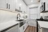 Newly Renovated Kitchen w/ White Cabinetry, Stainless Steel Appliances.