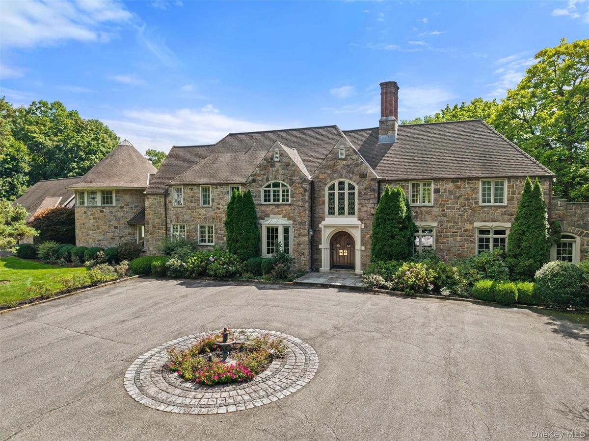 This Stone Manor home has a gated entrance, 200 foot driveway and welcoming approach