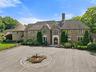 This Stone Manor home has a gated entrance, 200 foot driveway and welcoming approach