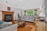 Bright living room with picture window and fireplace