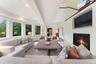 View of family room into kitchen with built in TV niche and Heatilator fireplace