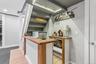 Custom bar featuring a wood-finish countertop, shiplap paneling, and a compact refrigerator
