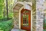 Entrance to property featuring stone siding